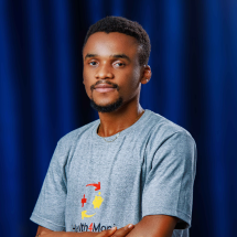 An image of a man standing with a smile, Chief Operations Officer of Health4Moni Health Insurance Company